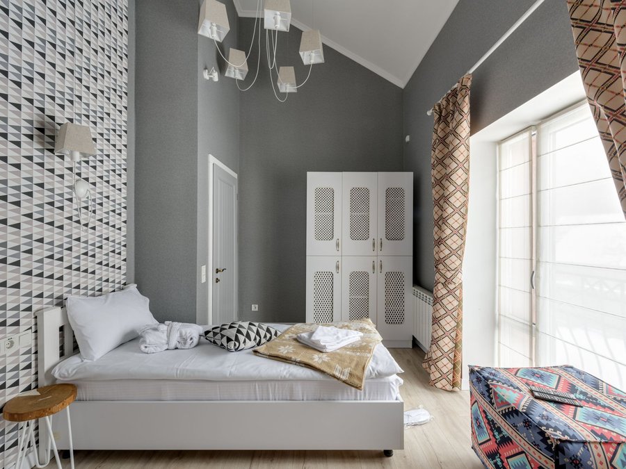 Bedroom feature wall covered in a white three-dimensional geometric relief pattern